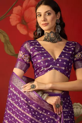 Purple silk cotton bandhni saree with unstitched blouse piece.