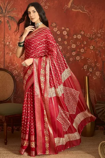 Red silk cotton bandhni saree with unstitched blouse piece.