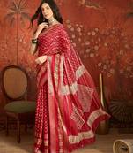 Red silk cotton bandhni saree with unstitched blouse piece.