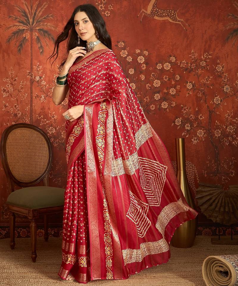 Red silk cotton bandhni saree with unstitched blouse piece.