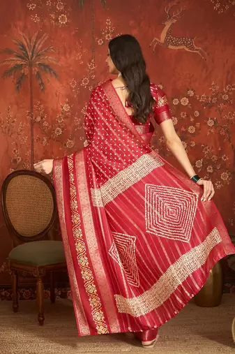 Red silk cotton bandhni saree with unstitched blouse piece.