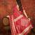Red silk cotton bandhni saree with unstitched blouse piece.