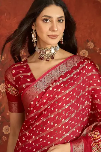 Red silk cotton bandhni saree with unstitched blouse piece.
