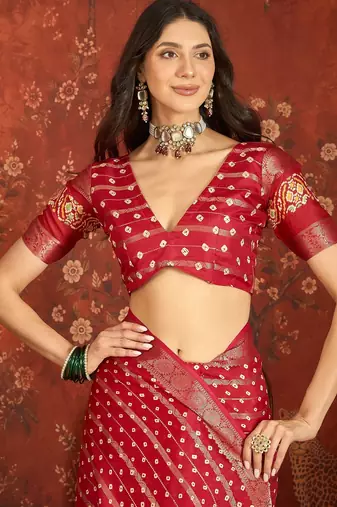Red silk cotton bandhni saree with unstitched blouse piece.