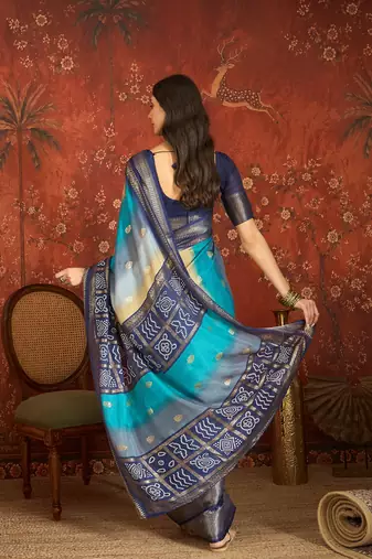 Blue silk cotton bandhni saree with unstitched blouse piece.