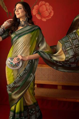 Green silk cotton bandhni saree with unstitched blouse piece.
