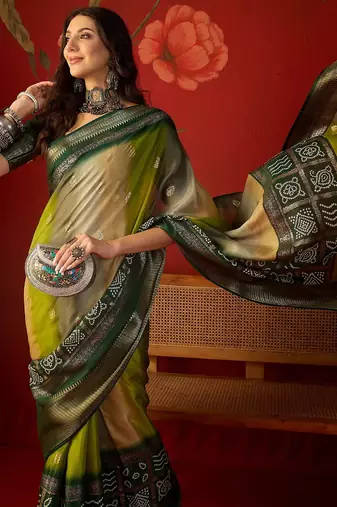Green silk cotton bandhni saree with unstitched blouse piece.