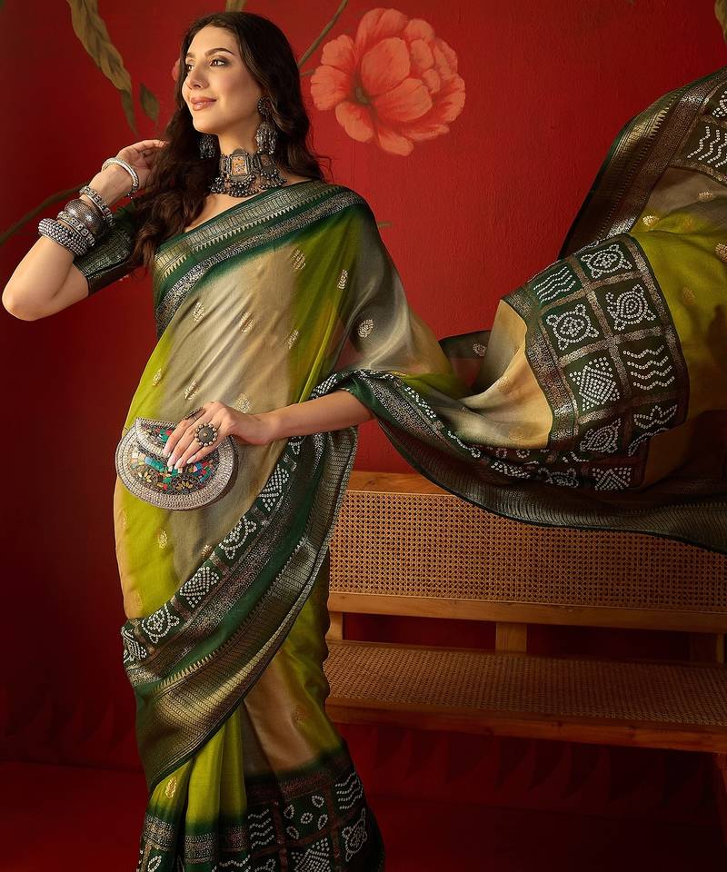 Green silk cotton bandhni saree with unstitched blouse piece.