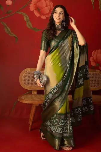 Green silk cotton bandhni saree with unstitched blouse piece.