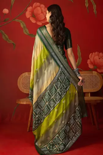 Green silk cotton bandhni saree with unstitched blouse piece.