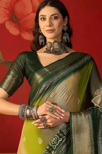 Green silk cotton bandhni saree with unstitched blouse piece.