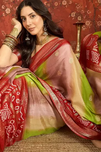 Red silk cotton bandhni saree with unstitched blouse piece.