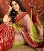 Red silk cotton bandhni saree with unstitched blouse piece.