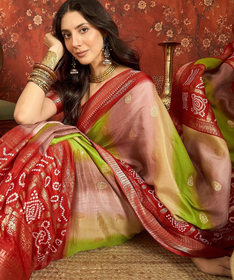 Red silk cotton bandhni saree with unstitched blouse piece.