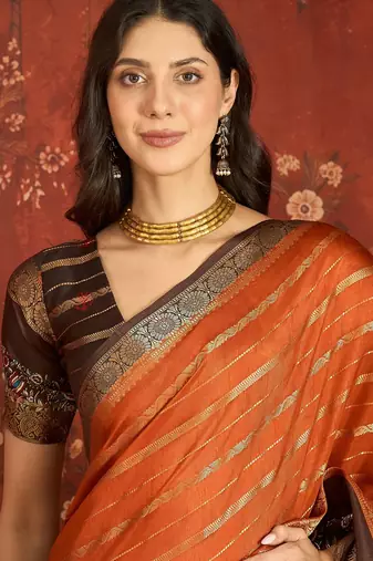 Orange silk cotton zari saree with unstitched blouse piece.