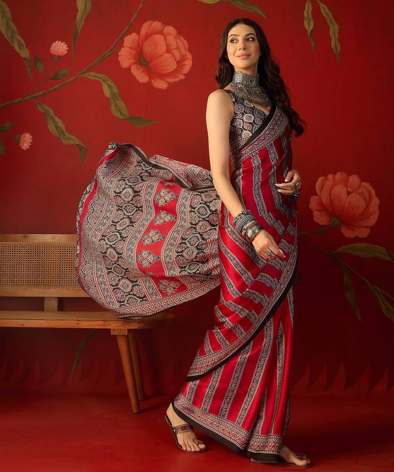 Red satin ajrakh printed saree with unstitched blouse piece.