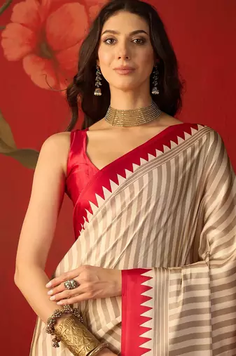Beige satin printed saree with unstitched blouse piece.