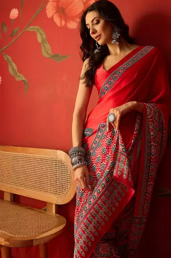 Red satin ajrakh printed saree with unstitched blouse piece.