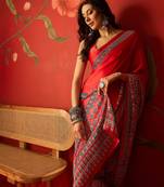 Red satin ajrakh printed saree with unstitched blouse piece.