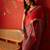 Red satin ajrakh printed saree with unstitched blouse piece.