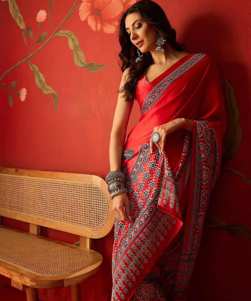 Red satin ajrakh printed saree with unstitched blouse piece.
