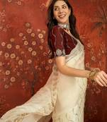 Cream tissue embroidered saree with unstitched blouse piece.