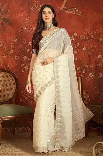 Cream tissue embroidered saree with unstitched blouse piece.