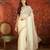 Cream tissue embroidered saree with unstitched blouse piece.