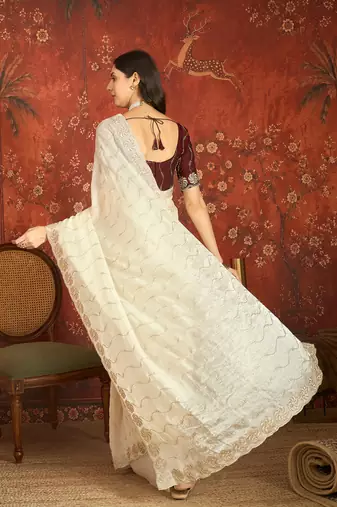 Cream tissue embroidered saree with unstitched blouse piece.