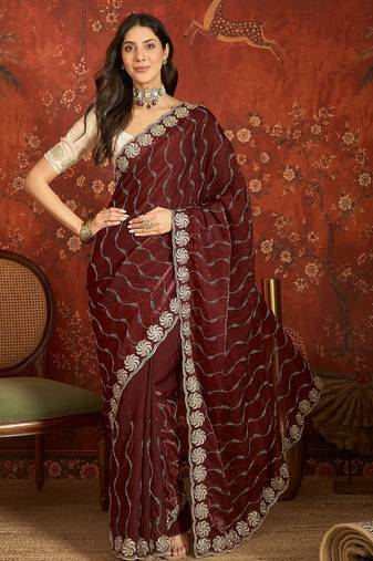 Maroon tissue embroidered saree with unstitched blouse piece.