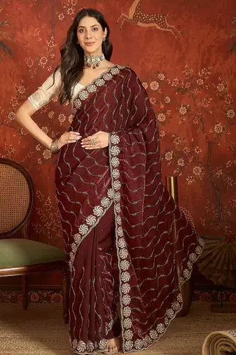 Maroon tissue embroidered saree with unstitched blouse piece.