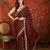 Maroon tissue embroidered saree with unstitched blouse piece.