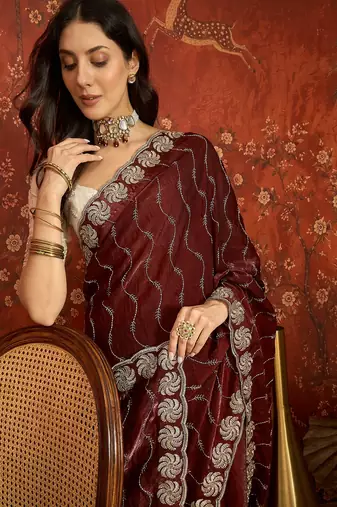 Maroon tissue embroidered saree with unstitched blouse piece.