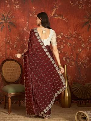 Maroon tissue embroidered saree with unstitched blouse piece. 3