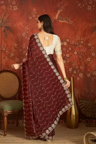 Maroon tissue embroidered saree with unstitched blouse piece.