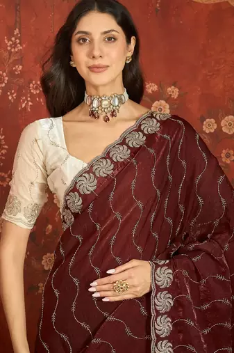 Maroon tissue embroidered saree with unstitched blouse piece.