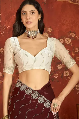 Maroon tissue embroidered saree with unstitched blouse piece.