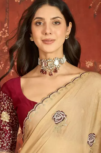 Beige silk blend embroidered saree with unstitched blouse piece.