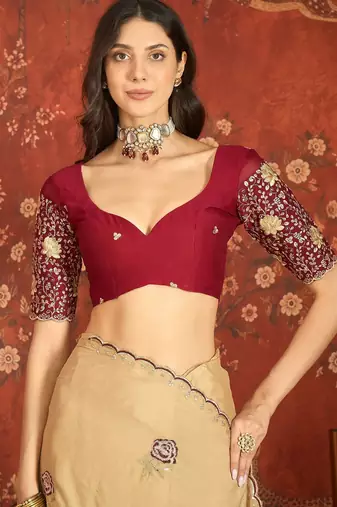 Beige silk blend embroidered saree with unstitched blouse piece.