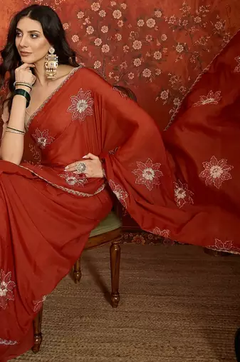 Rust chiffon embroidered saree with unstitched blouse piece.