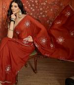 Rust chiffon embroidered saree with unstitched blouse piece.