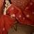 Rust chiffon embroidered saree with unstitched blouse piece.