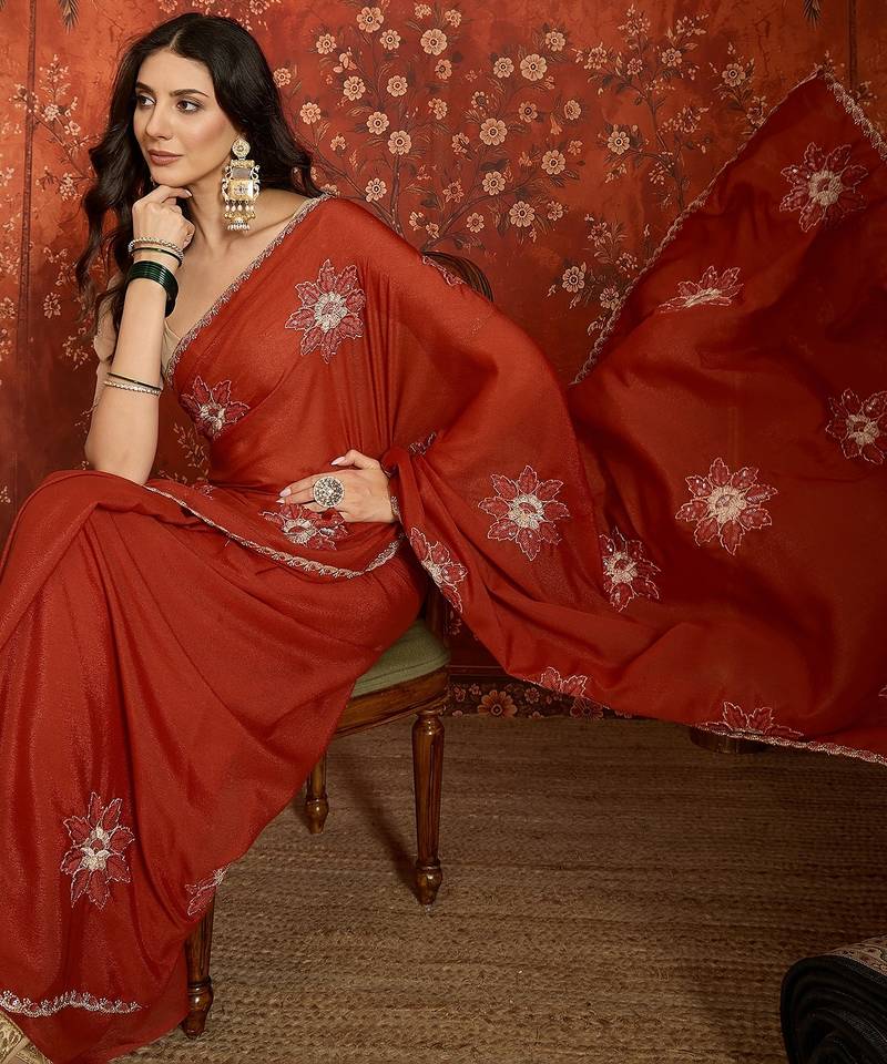 Rust chiffon embroidered saree with unstitched blouse piece.