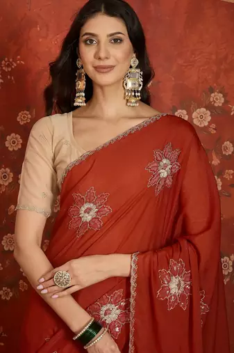 Rust chiffon embroidered saree with unstitched blouse piece.