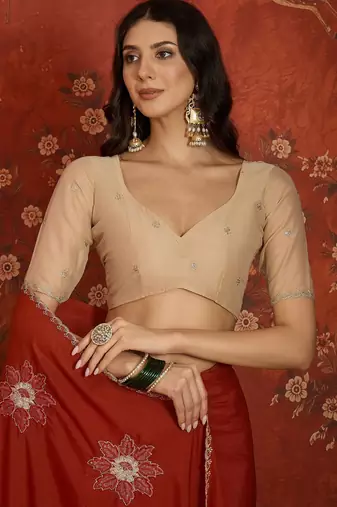 Rust chiffon embroidered saree with unstitched blouse piece.