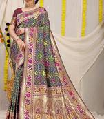 Dark green patola silk blend saree with blouse piece