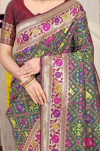 Dark green patola silk blend saree with blouse piece