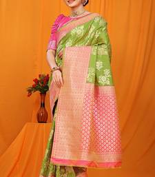 Light green banarasi silk blend saree with pink zari woven border