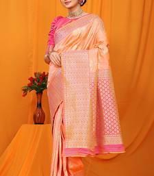 Peach banarasi silk blend saree with pink zari woven border