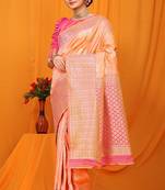 Peach banarasi silk blend saree with pink zari woven border